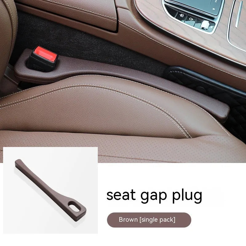 Flexible polyurethane car seat gap strip in black colour lying next to a car seat.