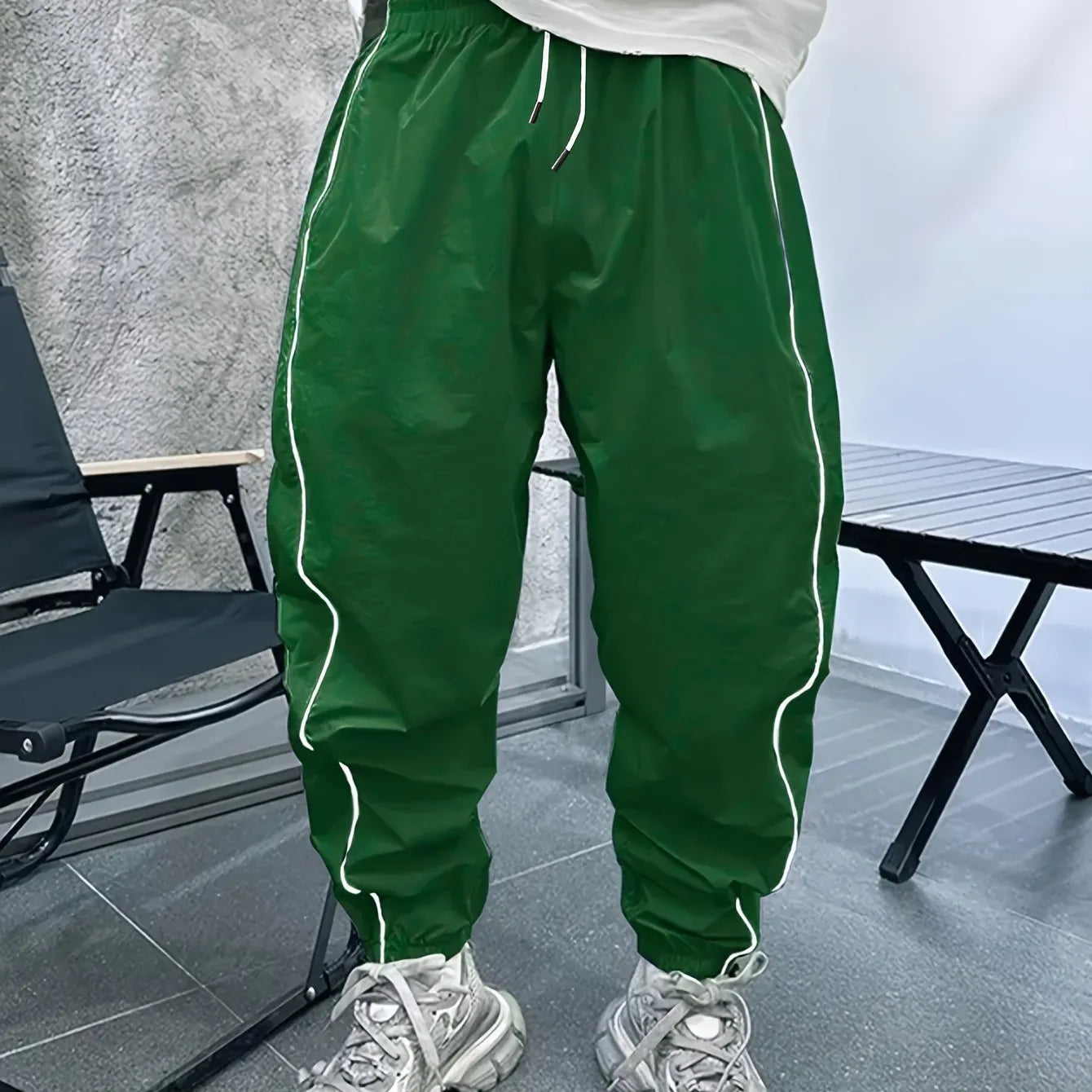 Men's loose blue bamboo fibre cropped sports trousers on a grey background