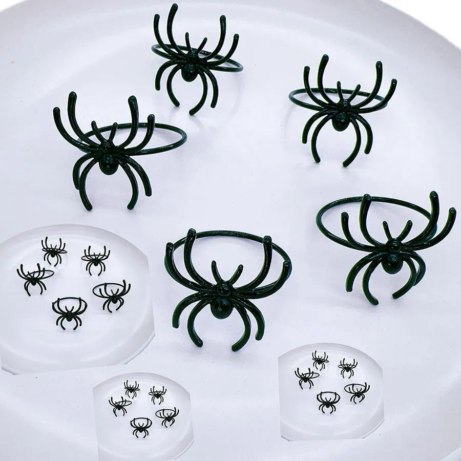 Six black metal spider napkin rings for Halloween table decoration