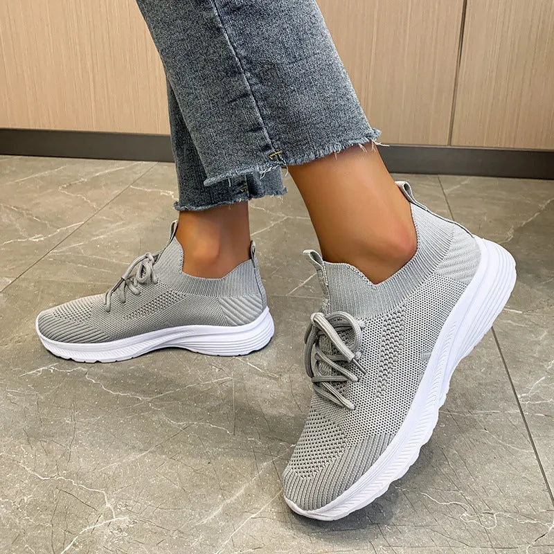Women's mesh running shoes in Creamy White colour with Flyknit upper and rubber sole