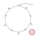 Simple silver anklet with a geometric zirconium pendant in gold colour