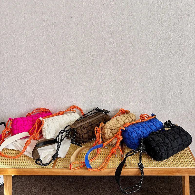 Soft pillow-shaped nylon messenger bag in multiple colours with a single shoulder strap.