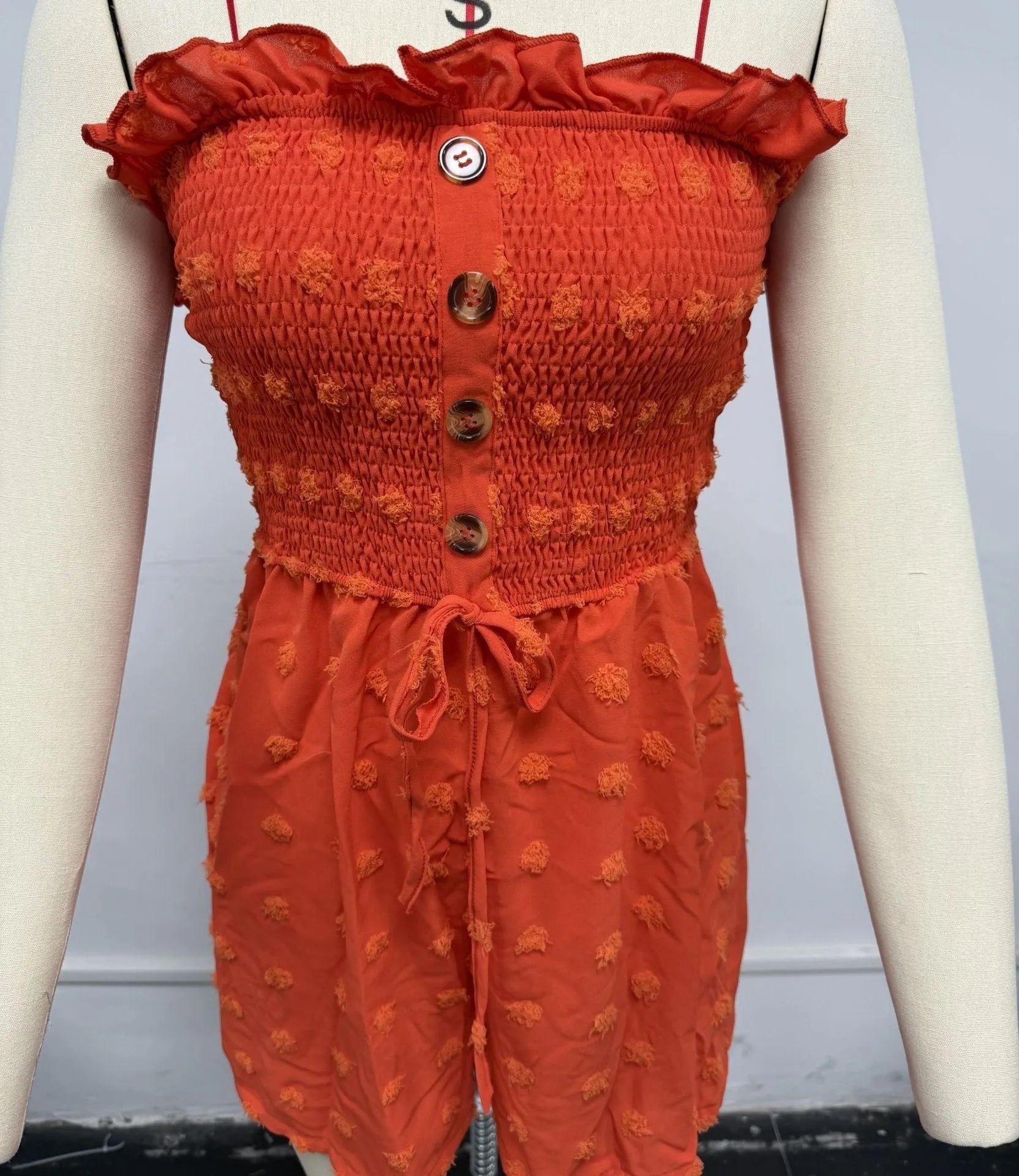 Women's solid colour off-shoulder sleeveless jumpsuit on a hanger