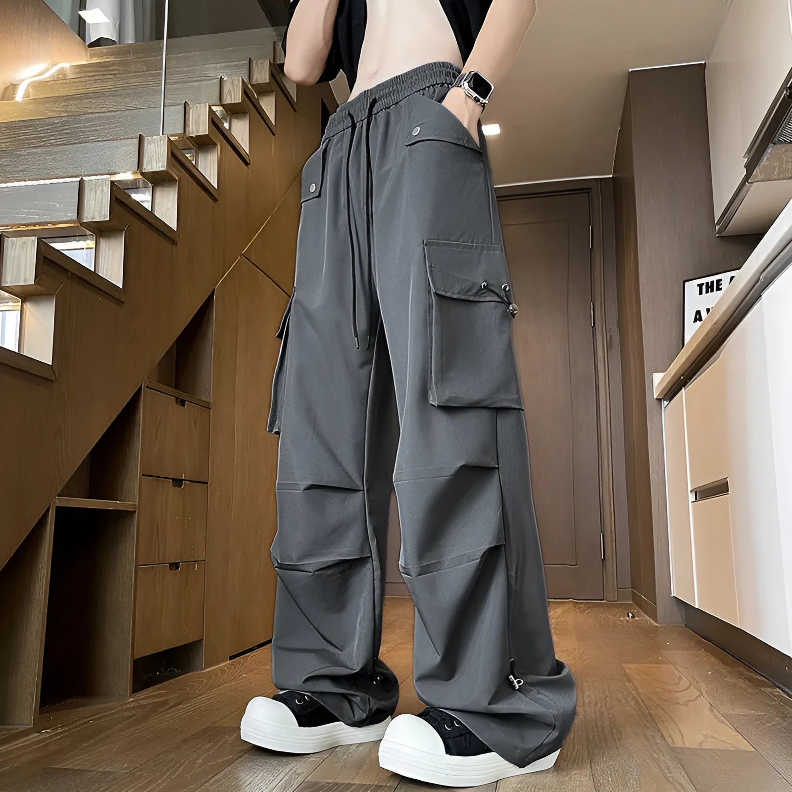 Women's plus size loose fit waterproof trousers in black, grey, or white, featuring a straight leg and elastic drawstring waist.