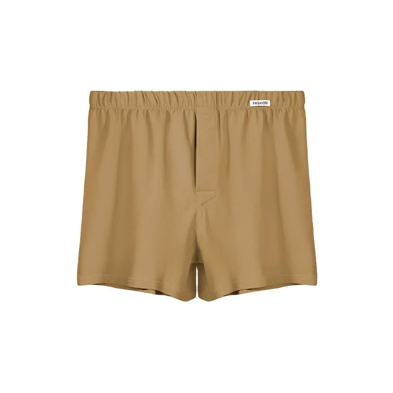 Men's loose-fitting cotton boxer shorts in solid colours like gold and green.