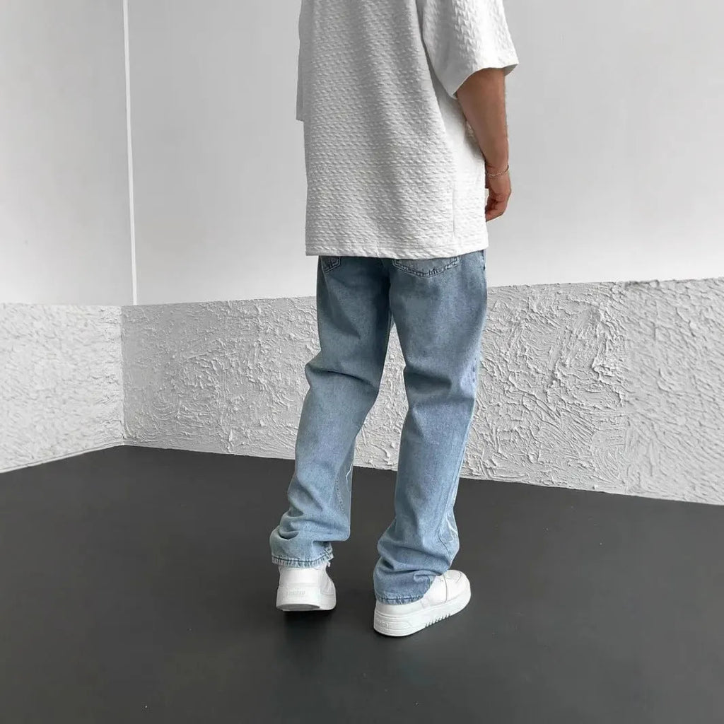 Men's blue straight-leg denim jeans with wide leg cut and mid waist design