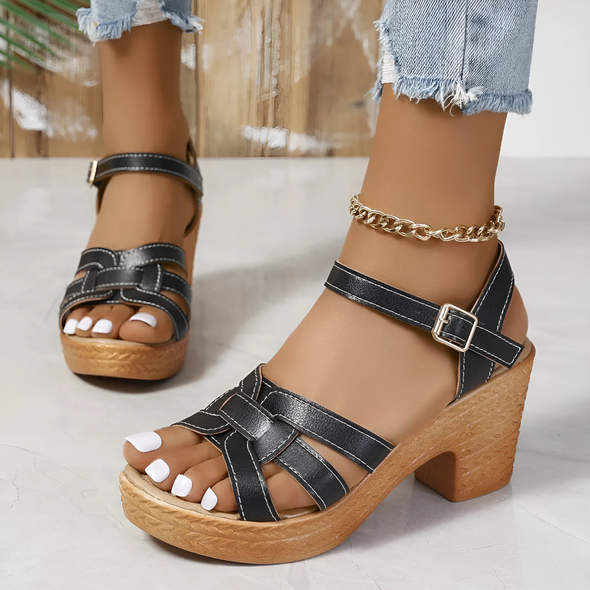 Plus size black women's sandals with peep toe, chunky heel, and ankle buckle strap on a white background.