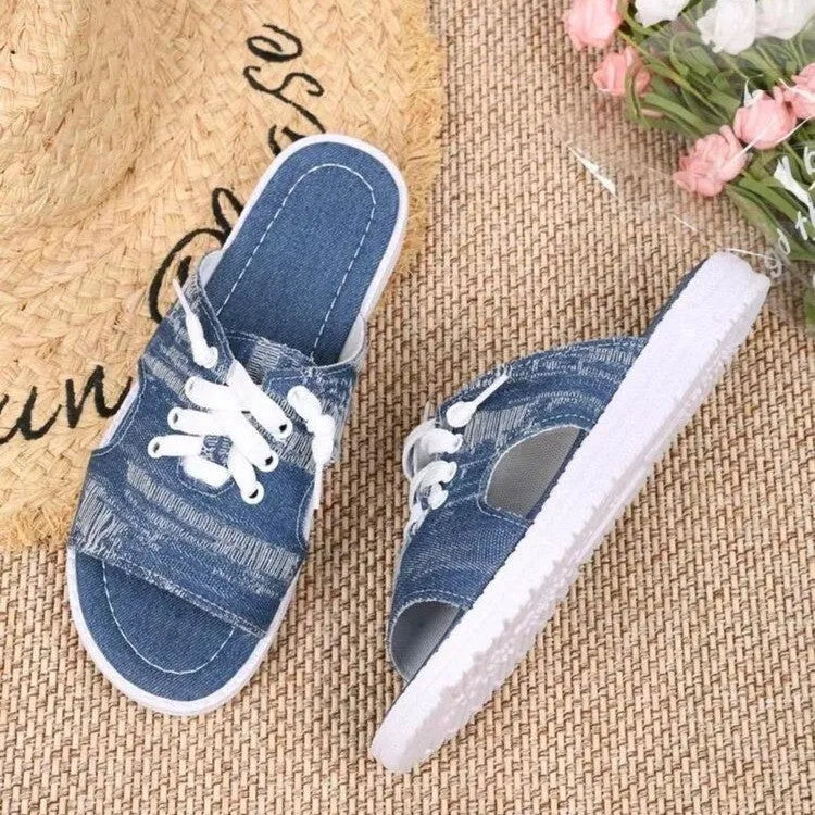 Blue Roman-style women's canvas slippers with rubber soles showing flat design and cloth upper material
