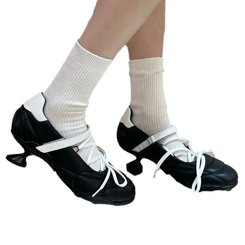 Women's silver low-top sports shoes with front lace-up and bow detail on a round toe.