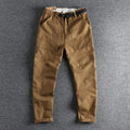 Cotton work trousers in khaki colour with mid waist design and zip fly closure
