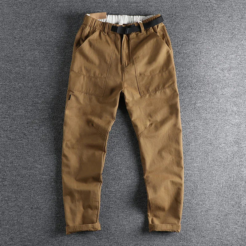 Cotton work trousers in khaki colour with mid waist design and zip fly closure