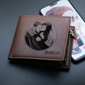 Men's brown leather wallet with a silver zipper fastening, shown open to reveal multiple card slots.