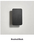 Minimalist Nordic style LED wall lamp in black finish mounted on wall showing adjustable light feature