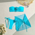 Women's pink tie-front tube top bikini set with large 3D flower and matching skirt.