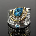 Blue Chinese style alloy ring with inlaid rhinestones in a drop shape on a white background.