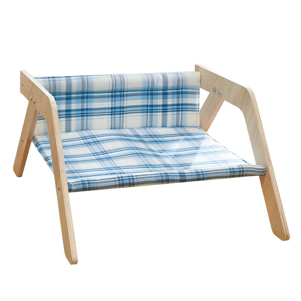 Elevated wooden frame cat bed with soft blue cloth cushion for indoor cats.
