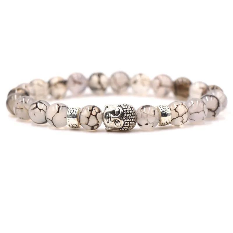 Tigereye stone Buddha head stretch bracelet with 8mm beads on a wrist.