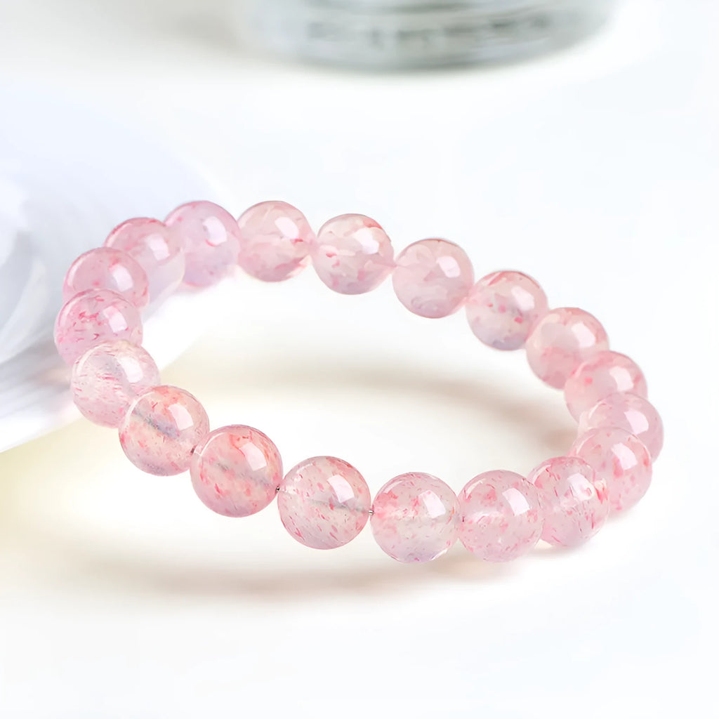 Strawberry quartz crystal bracelet with spherical 10-10.8mm beads in white water colour