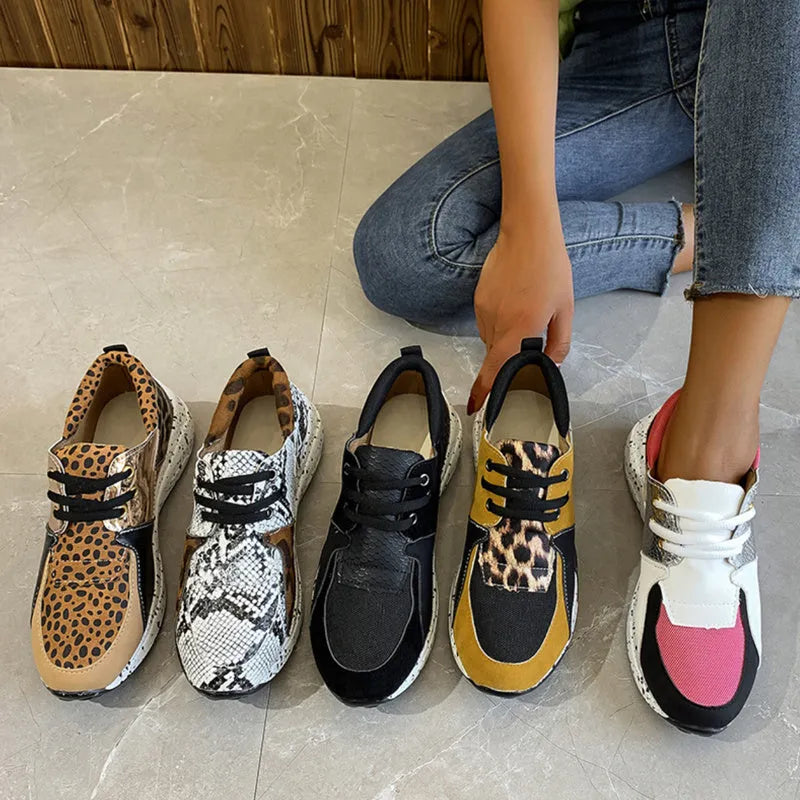 Women's black suede casual sneakers with a wedge heel on a white background