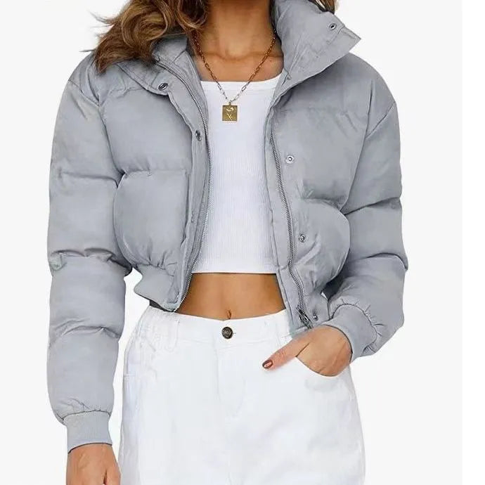 Blue loose fit polyester jacket for women with long sleeves on a hanger.