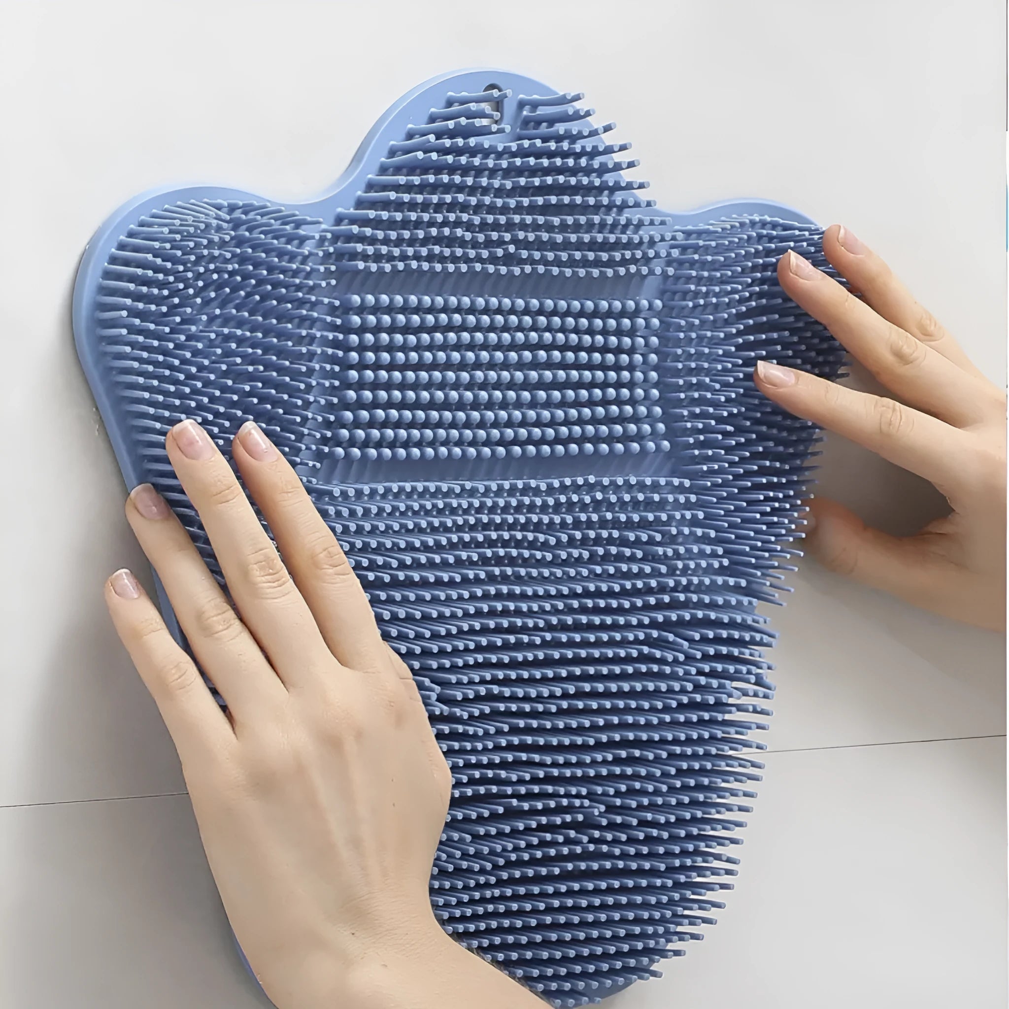 Blue silicone bath massage cushion with textured surface measuring 31cm by 32cm for bathing and relaxation