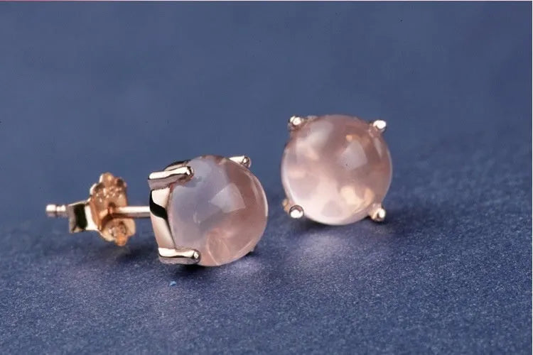 Rose gold drop shape stud earrings with synthetic ross quartz crystal inlay.