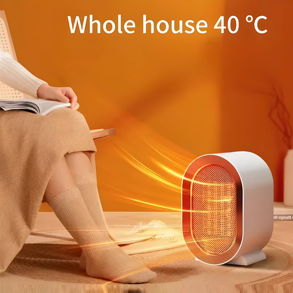 Compact black desktop electric fan heater with mechanical control dials and a safety grille.