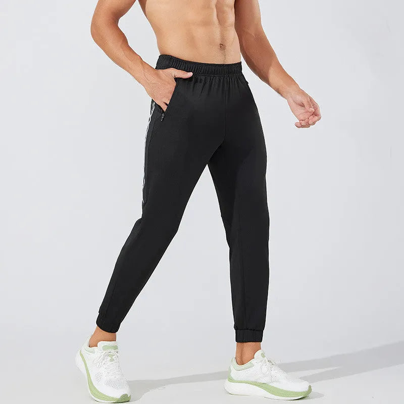 Men's black running trousers with mid waist design and polyester fabric for exercise activities