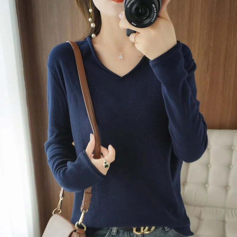 Women's V-neck long sleeve knitwear pullover top in a macaron colour on a hanger.