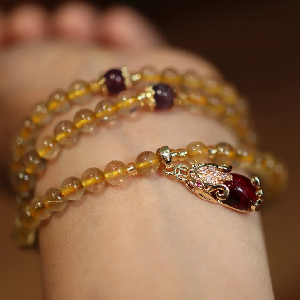 Natural rutilated quartz bracelet with gold rutile inclusions and Chinese style gold accent beads