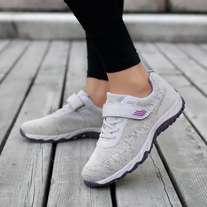 Women's low-top wedge heel shoes with mesh upper and Velcro strap in a solid colour.