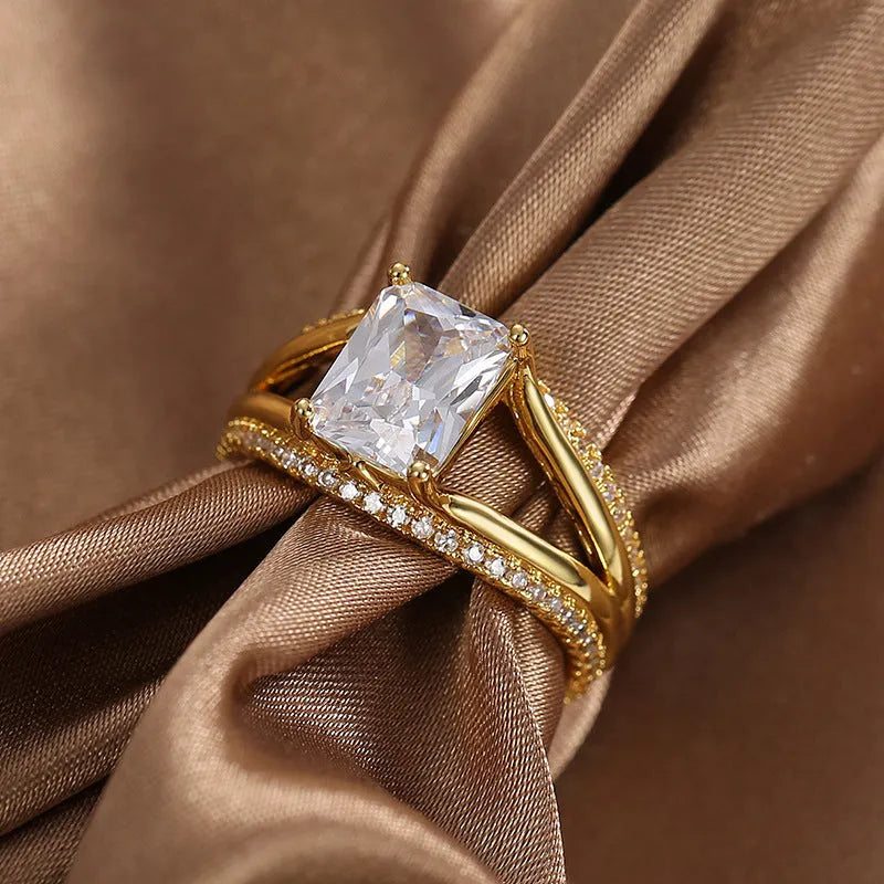 Geometric women's ring with gold electroplated finish and square zircon centrepiece on copper base