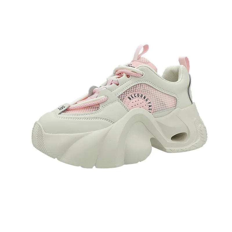 Women's pink sneakers with thick sole, cross ankle straps and mesh lining.