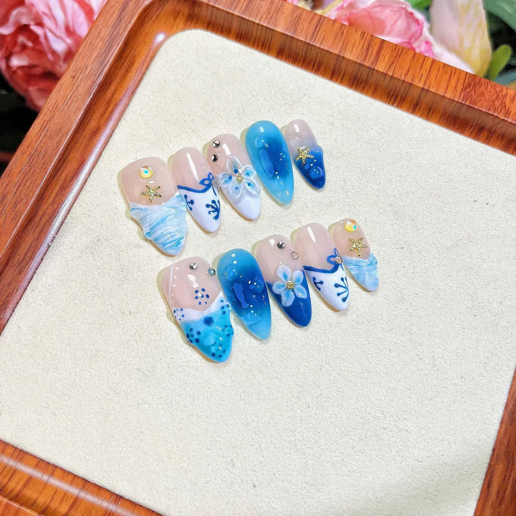 Blue hand-painted fake nails with carved transparent summer ice finish in four sizes