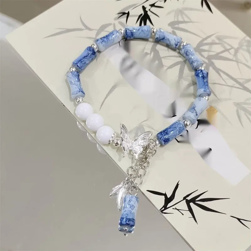 Handmade Chinese style glass bracelet with bamboo joint beads in a red Lvzhu Duobao design.