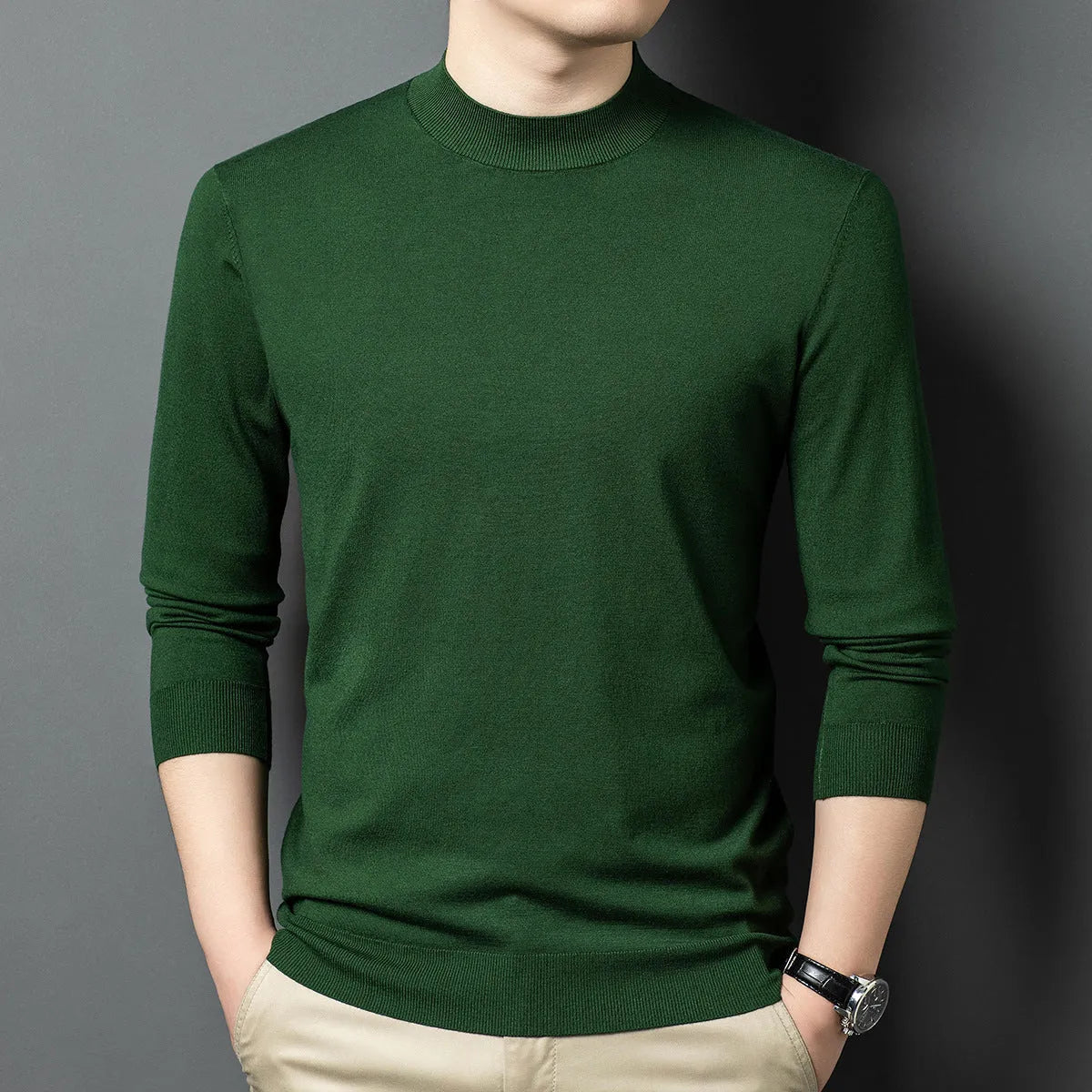 Man wearing a round neck long sleeve wool blend pullover sweater in a neutral colour.