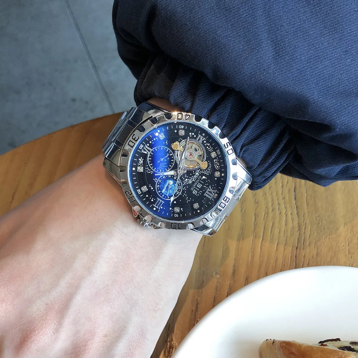 Men's silver case automatic mechanical watch with black starry dial and steel belt strap