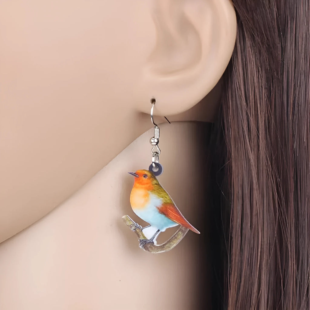 A pair of blue titmouse design pendant earrings made from printed acrylic on a geometric shape.