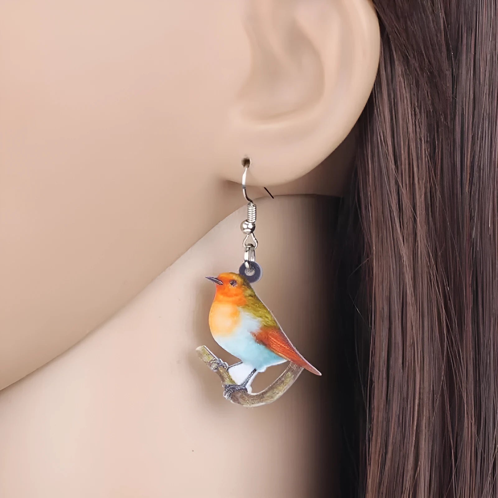 A pair of blue titmouse design pendant earrings made from printed acrylic on a geometric shape.
