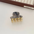 Medium metal grip acetate hair barrettes in four colours: fairy white, leopard print, creamy-white, and ink colour