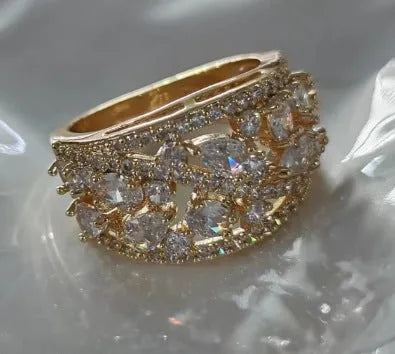 Women's hollow round fashion ring in gold or platinum with a choice of white or blue gemstone.