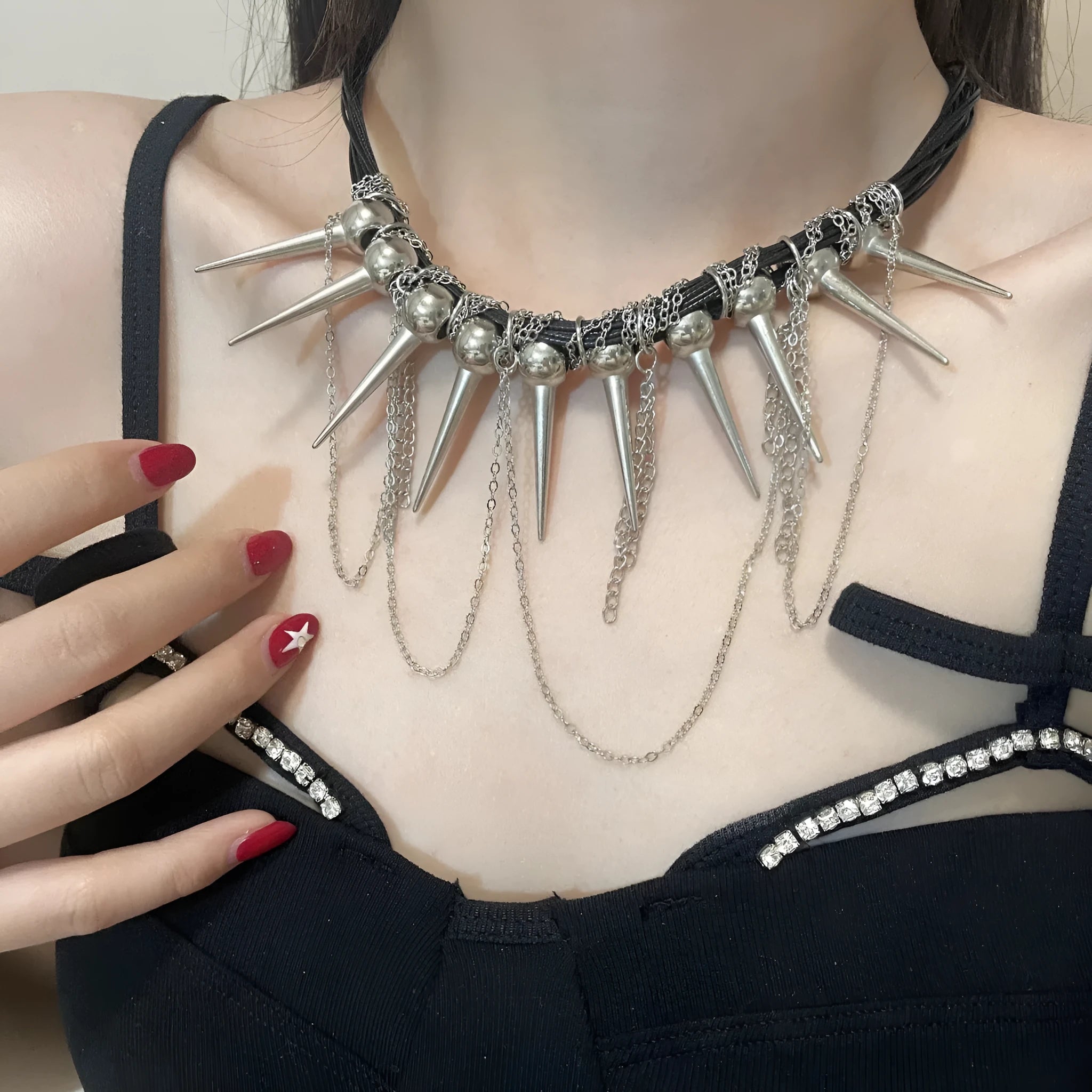 Women's leather necklace with round beads, a winding tassel, and metallic point rivets.