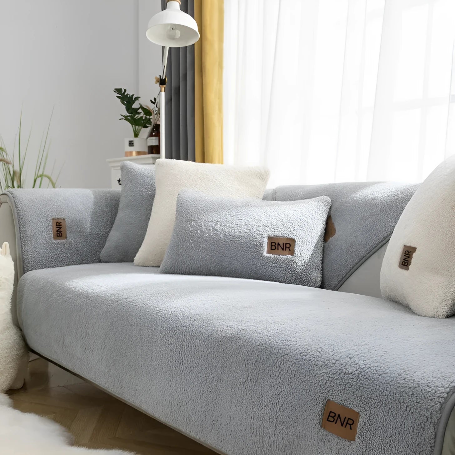 Lambswool sofa slipcover in solid blue colour on a grey sofa