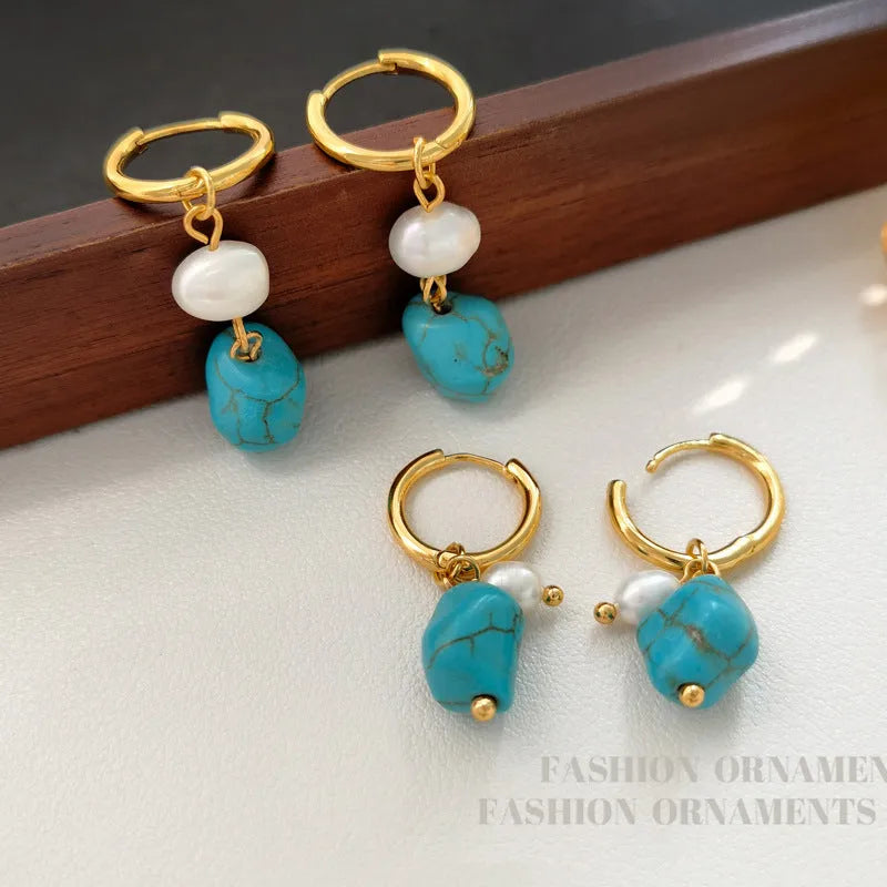 Geometric turquoise and cultured pearl earrings in short stud and long dangle styles on copper settings.