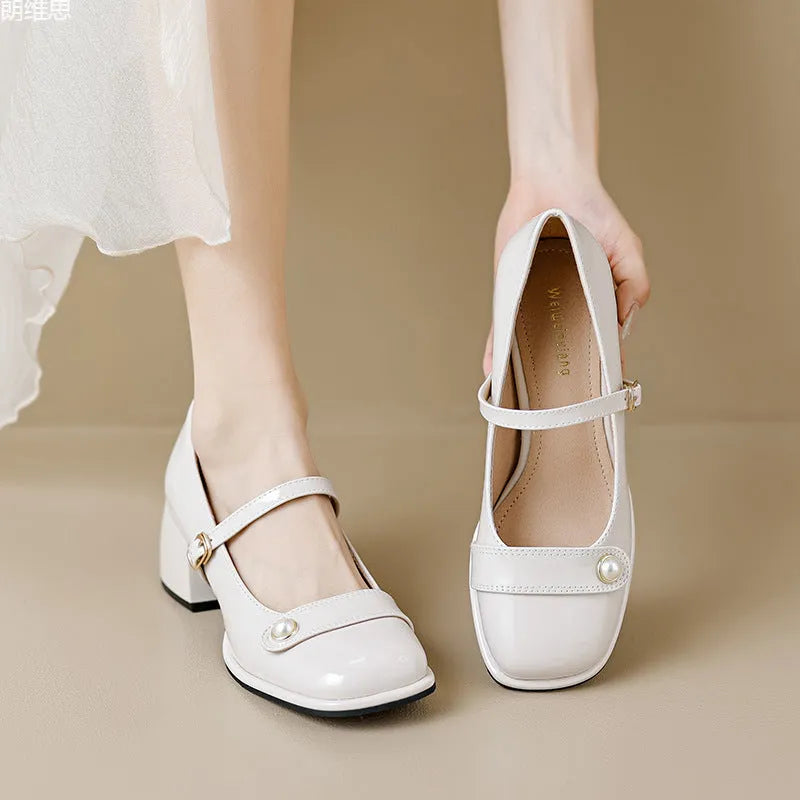Women's apricot patent leather heel pumps with a chunky block heel and buckle fastening