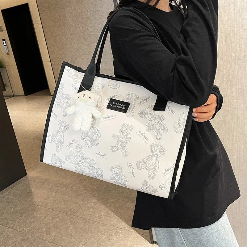 Women's soft canvas tote bag in black, showing large capacity, sandwich pockets, and a rhombus pattern detail.