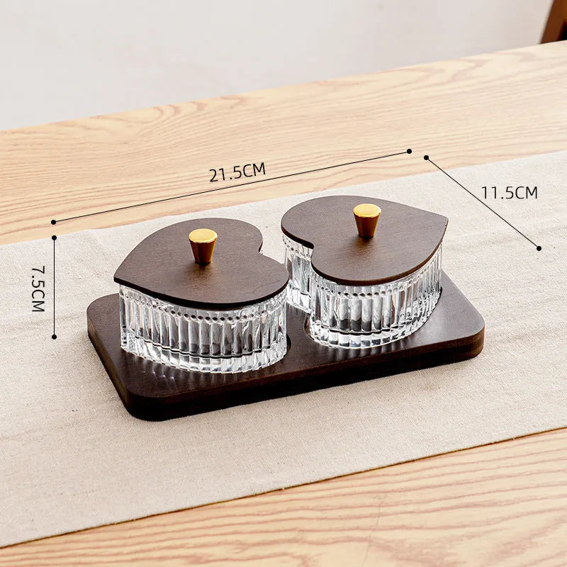 Glass fruit platter with transparent heart-shaped lids covering compartmentalised snack trays in retro design