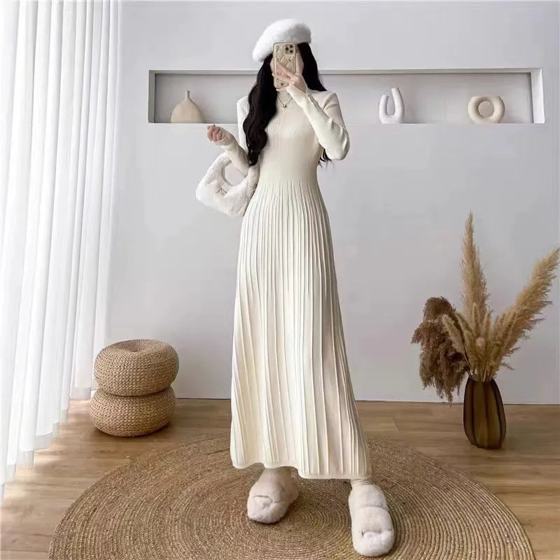 Women's high-waist knitted A-line skirt dress in a solid colour, mid-length below the knees.