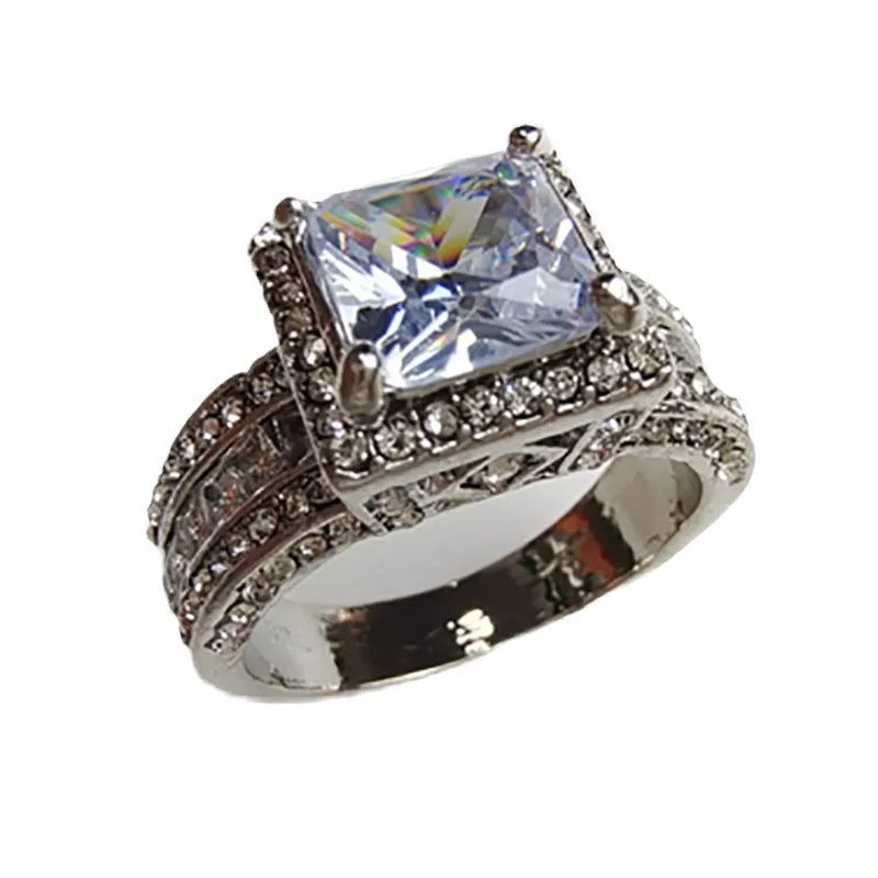Geometric women's alloy ring with round details in gold or white electroplated finish.