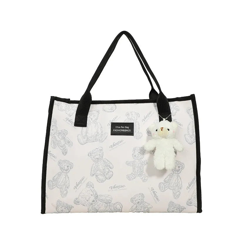 Women's soft canvas tote bag in black, showing large capacity, sandwich pockets, and a rhombus pattern detail.